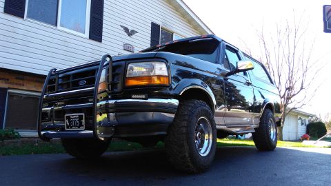 1996 Ford Bronco - Black 1996 Ford Bronco with a chrome push bar and aftermarket wheels.