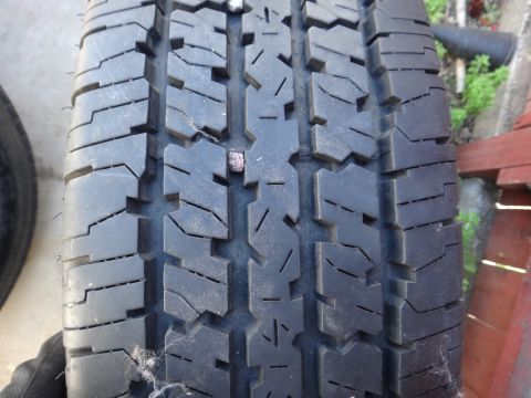 1995 Chevrolet P30 1 Ton - Step Van - A close-up of a tire tread shows a nail stuck in the rubber.