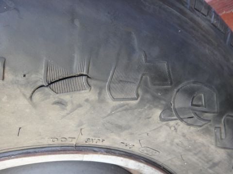 1995 Chevrolet P30 1 Ton - Step Van - This close-up shows a damaged tire tread, with some DOT markings visible on the sidewall.