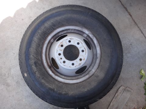 1995 Chevrolet P30 1 Ton - Step Van - A single tire and wheel assembly is shown resting on a concrete surface.