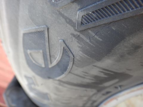 1995 Chevrolet P30 1 Ton - Step Van - Tire tread detail with a prominent logo and visible cracking.