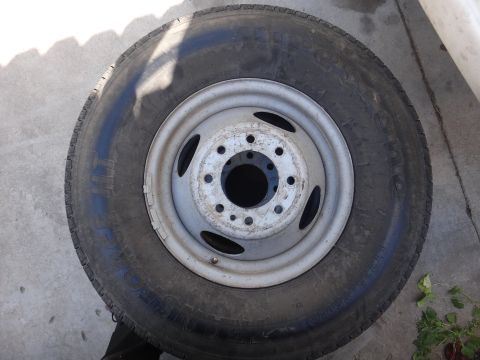 1995 Chevrolet P30 1 Ton - Step Van - A single wheel and tire assembly is shown, likely from a heavy-duty vehicle, resting on a concrete surface.