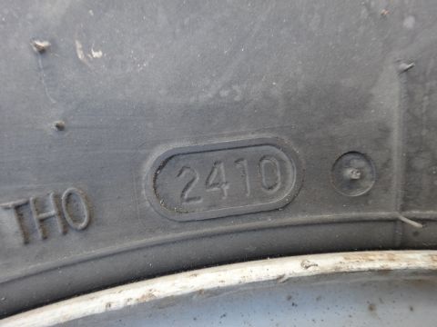 1995 Chevrolet P30 1 Ton - Step Van - Close-up of a tire sidewall revealing the DOT code 2410, indicating the tire was manufactured in the 24th week of 2010.