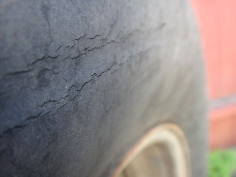 1995 Chevrolet P30 1 Ton - Step Van - Close-up of a cracked tire, indicating wear and potential failure.