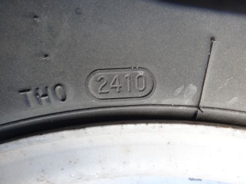 1995 Chevrolet P30 1 Ton - Step Van - Close-up of a tire's sidewall reveals the DOT code, indicating its manufacturing date.