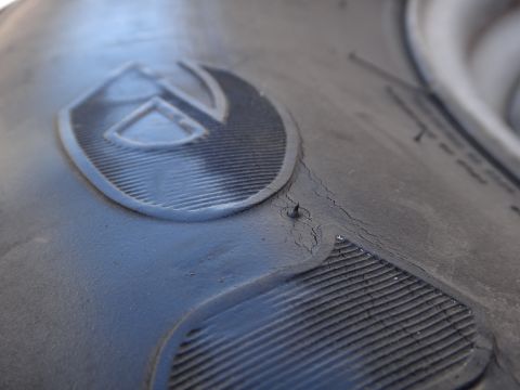 1995 Chevrolet P30 1 Ton - Step Van - Close-up view of a tire's tread and a prominent logo, with a Supermotors.net watermark in the corner.
