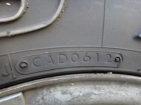 1995 Chevrolet P30 1 Ton - Step Van - Close-up of a tire sidewall showing the DOT code, which reveals the manufacturing date.
