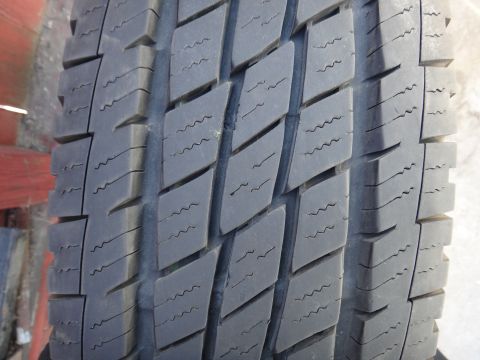 1995 Chevrolet P30 1 Ton - Step Van - A detailed view of a tire's tread pattern, showing the block design and sipes.