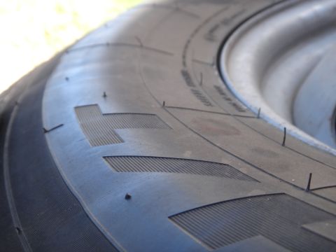 1995 Chevrolet P30 1 Ton - Step Van - A detailed view of a tire's tread shows its pattern and some text on the sidewall.