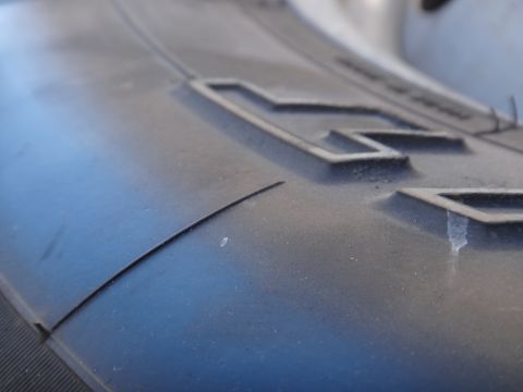 1995 Chevrolet P30 1 Ton - Step Van - A detailed view of a tire's tread pattern, showing the raised blocks and a distinct curved line on the surface.