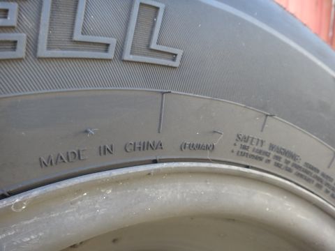 1995 Chevrolet P30 1 Ton - Step Van - Close-up of a tire's sidewall showing manufacturing origin and safety information.