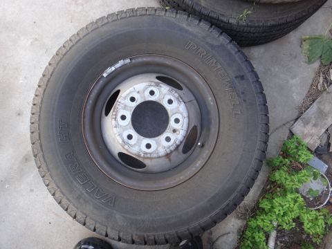 1995 Chevrolet P30 1 Ton - Step Van - A single truck wheel and tire assembly is shown, with another tire partially visible behind it.