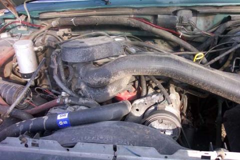 1987 Ford Bronco - Close-up view of a vehicle's engine compartment, showing various mechanical parts and wiring.