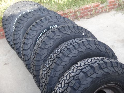 1995 Chevrolet P30 1 Ton - Step Van - A set of BFGoodrich All-Terrain T/A tires are lined up on a paved surface.