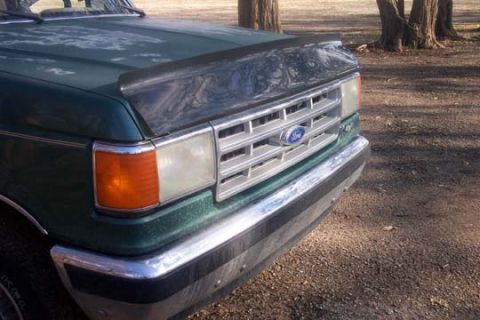 1987 Ford Bronco - The front grille and bumper of a green 1987 Ford Bronco are visible.