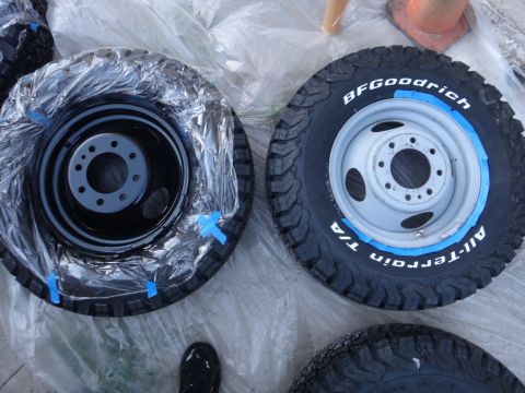 1995 Chevrolet P30 1 Ton - Step Van - Two tires are prepared for painting, with one wheel covered in plastic wrap and tape.