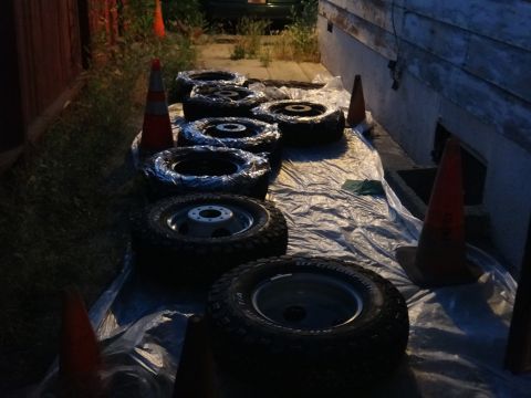 1995 Chevrolet P30 1 Ton - Step Van - Tires and rims are staged on plastic sheeting, possibly for a project or storage.