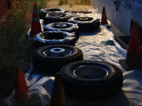 1995 Chevrolet P30 1 Ton - Step Van - A collection of tires and wheels are arranged on a tarp, marked by traffic cones.