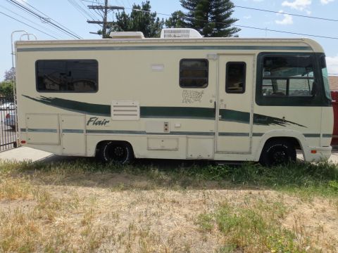 1995 Chevrolet P30 1 Ton - Step Van - Side view of a motorhome with green stripe and 'Flair' badging.