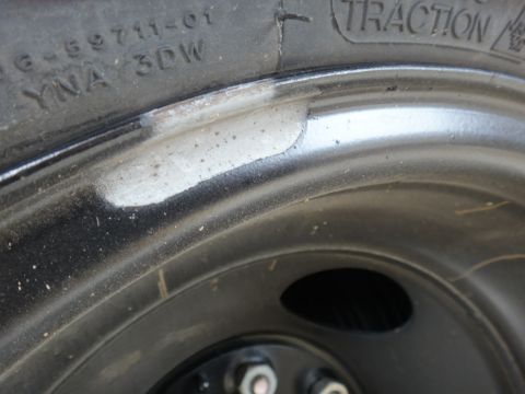 1995 Chevrolet P30 1 Ton - Step Van - A close-up view of a tire's sidewall and a black steel wheel, showing a DOT code and tread detail.
