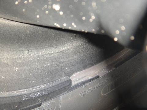 1995 Chevrolet P30 1 Ton - Step Van - A detailed view of a tire's sidewall and wheel rim, showing some text and accumulated dust.