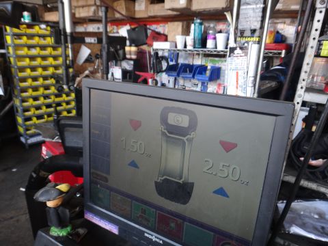 1995 Chevrolet P30 1 Ton - Step Van - A wheel balancing machine displays readings in a cluttered garage setting.