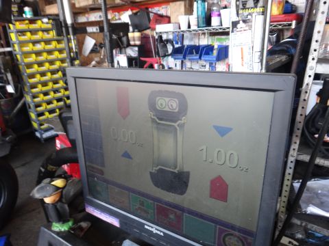 1995 Chevrolet P30 1 Ton - Step Van - Tire balancing machine display shows readings of 0.00 oz and 1.00 oz.