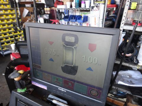 1995 Chevrolet P30 1 Ton - Step Van - A wheel balancing machine displays readings of 0.75 oz and 1.00 oz on its screen.