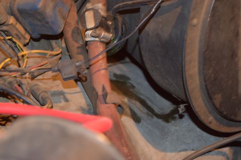1978 Ford Bronco - A detailed view of engine components, showing wiring and some fluid leakage.