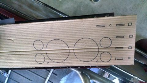 1985 Jeep CJ7 - A piece of cardboard with circles and rectangles drawn on it is placed over a metal frame. The cardboard appears to be a template for cutti…