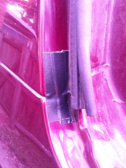 1996 Ford Bronco - Duct tape repair on the door frame of a vehicle.
