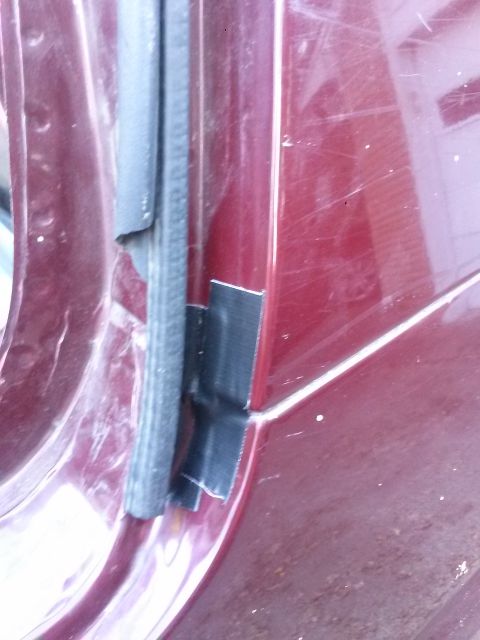 1996 Ford Bronco - The door seal on this vehicle is damaged and has been repaired with black tape.