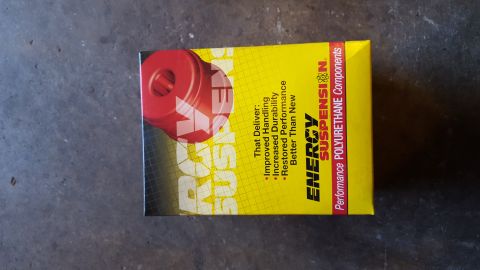 1994 Ford Bronco - A yellow box for Energy Suspension polyurethane components is shown, featuring a red polyurethane bushing and text detailing product benefi…