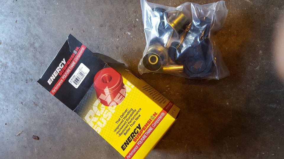Energy Suspension polyurethane parts box and bag of bushings on concrete.