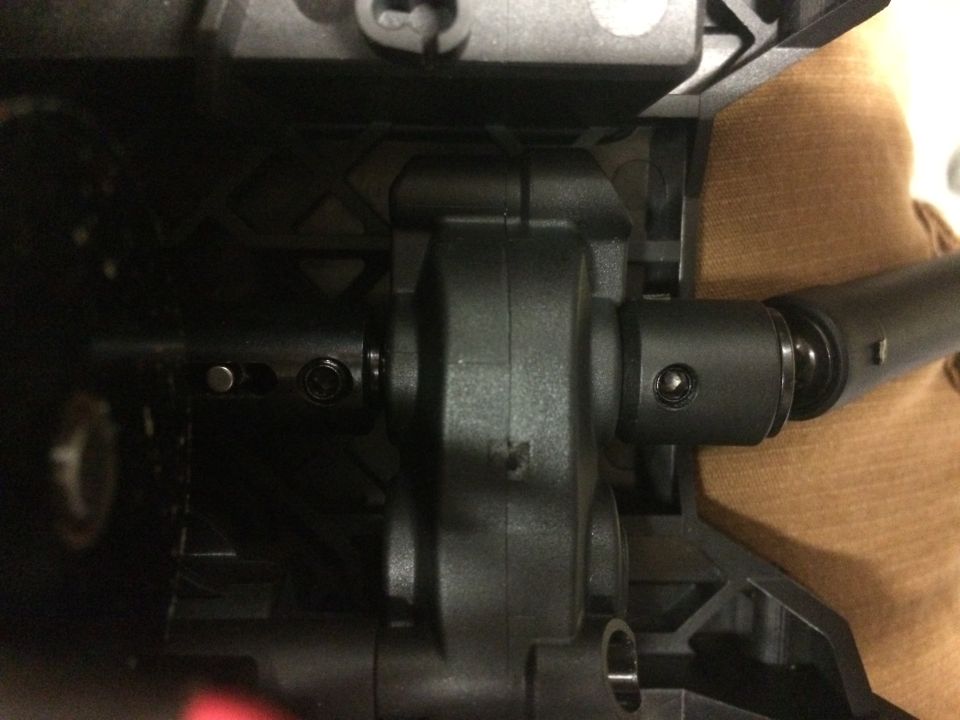 Close-up of vehicle drivetrain components, including differential housing and driveshaft.
