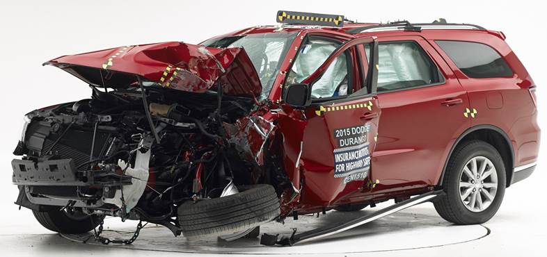 Heavily damaged red 2015 Dodge Durango SUV after crash test, front end crumpled, airbags deployed.