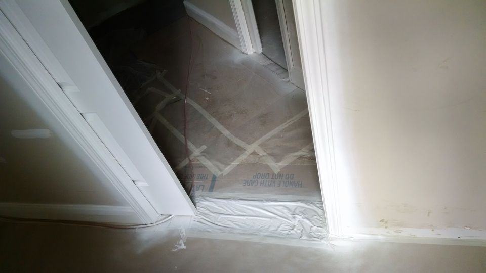 The painters put down the first full coat, but over a lot of sheetrock problems, and over a lot of door hardware.