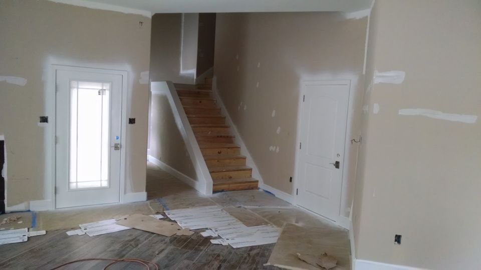 The painters put down the first full coat, but over a lot of sheetrock problems, and over a lot of door hardware.  They covered some things, but not this door's window.
