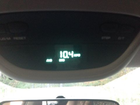 1979 Ford Bronco - A close-up of a digital display inside a vehicle shows the temperature as 10.4 degrees. The display is green and located in the overhead co…