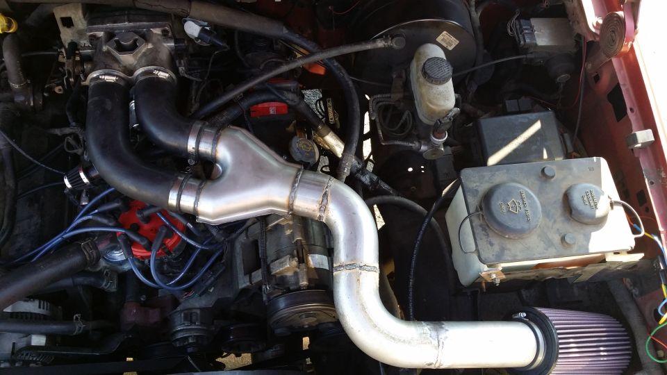 As promised, a better, more in focus picture. Welds still suck but hey, I am getting better. If you are looking for max power felt, stick with the K&N setup. With this setup I feel better midrange, virtually no top end and a little bit better low end than with the K&N. It has a nice baritone note and since it's farther away from me than the K&N setup, quieter too. It mixes with the exhaust and produces a really nice sound. Power delivery is a lot nicer and more fun to drive around town now. There are two breathers that need to be addressed: one on the upper plenum and one on the oil fill tube. I just used some Spectre breather filters on them. Built from scratch 3 inch mandrel bent exhaust pipe I had and a 2.5-inch/3-inch exhaust y-pipe.