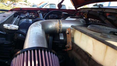 1996 Ford F-250 - Surprisingly flat. Nothing protrudes past the throttle body (vertically speaking). There is a bracket welded to the underside of the tube j…