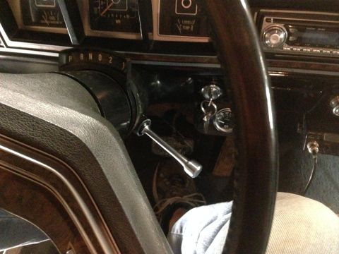 1979 Ford Bronco - Interior view of a vintage vehicle's dashboard and steering column, showing a P R N D 2 gear selector indicator and a key in the ignition.