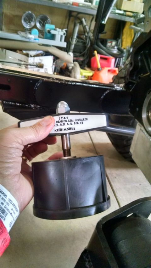 1985 Jeep CJ7 - A hand holds a Kent-Moore J 41479 Rear Oil Seal Installer tool, which is designed for 4.8L, 5.3L, 5.7L, and 6.0L V8 engines. The tool is po…
