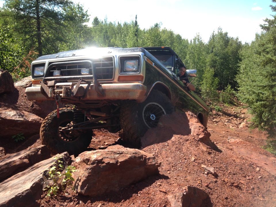 1979 Ford Bronco off-roading on a rocky trail.