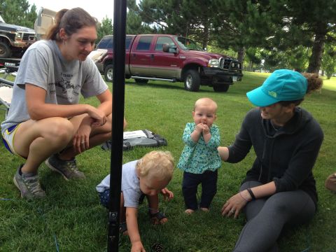1979 Ford Bronco - A maroon Ford F-250 Super Duty pickup truck is parked on a grassy field with trees in the background. Two women and two young children are…