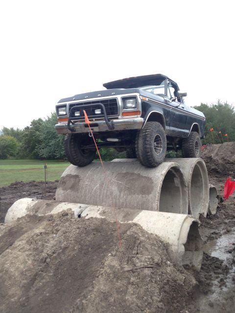 1979 Ford Bronco - Ford Bronco navigates an obstacle course made of concrete pipes and dirt mounds.
