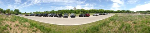 1979 Ford Bronco - Multiple vehicles are parked in a line on a sunny day.