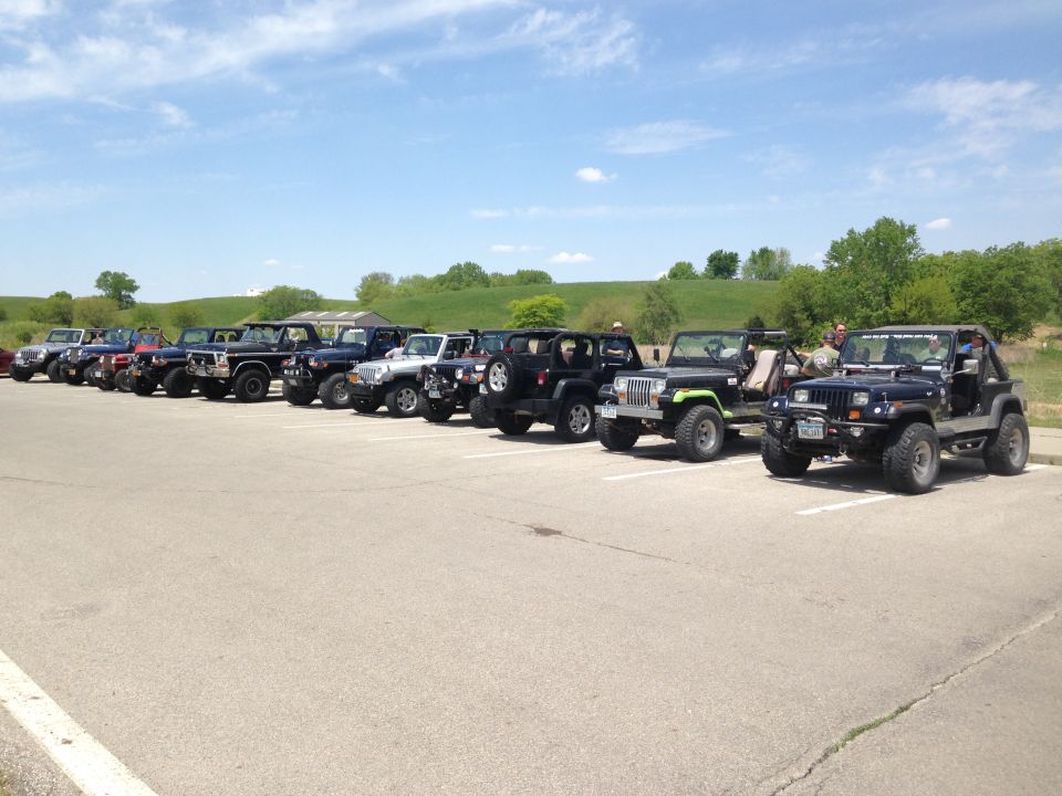 Line of Jeeps parked in a lot on a sunny day