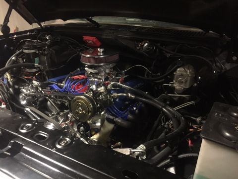 1982 Ford Bronco - Engine bay view showing the V8 engine, carburetor, and air filter assembly.