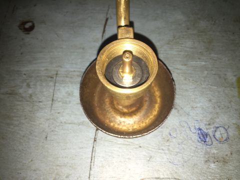 2014 Dodge 1500 - A close-up view of a brass fitting, possibly a valve component, resting on a textured surface.